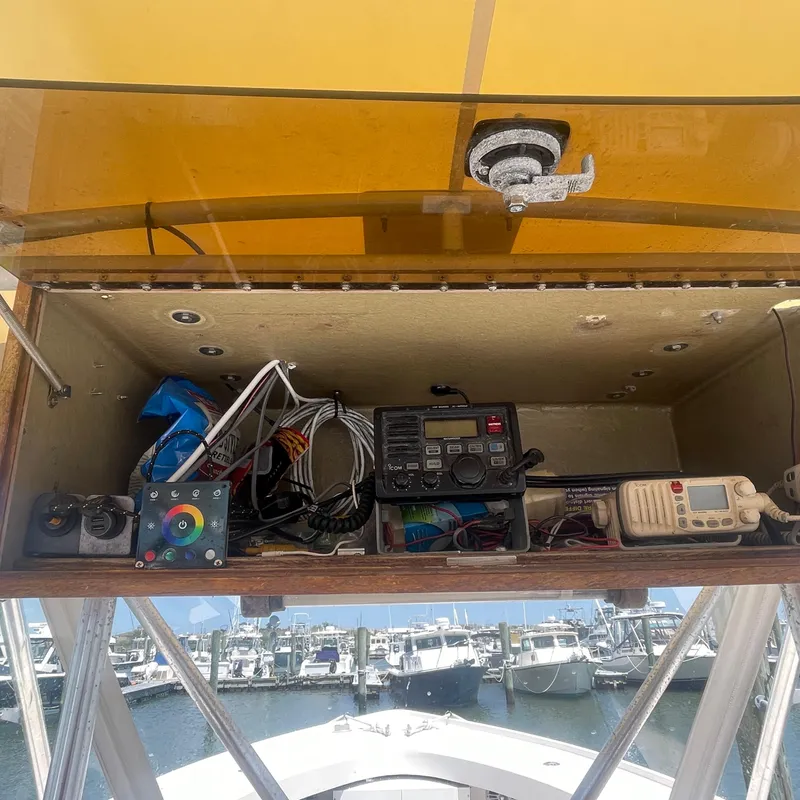 Slide: The Image of 1989 Rybo Runner Center Console electronics compartment with marine equipment and wiring. - 15