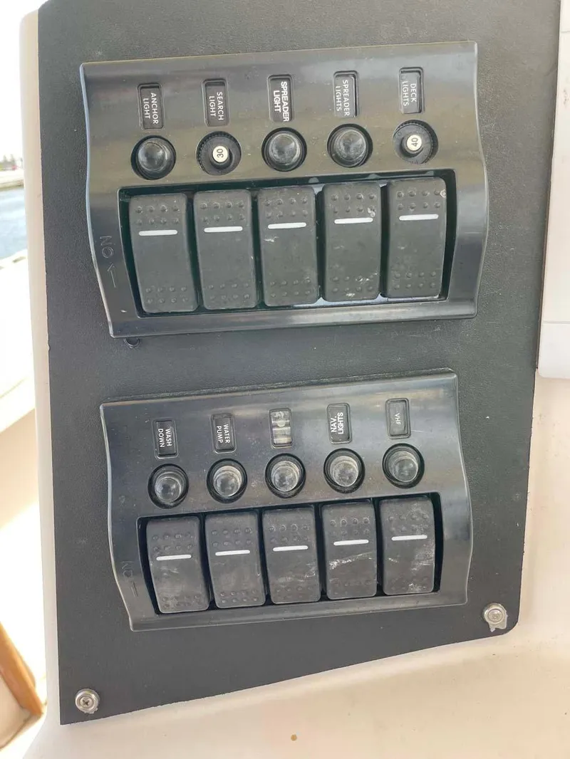 Slide: The Image of Control panel of a 1989 Rybo Runner Center Console boat with switches and buttons. - 16
