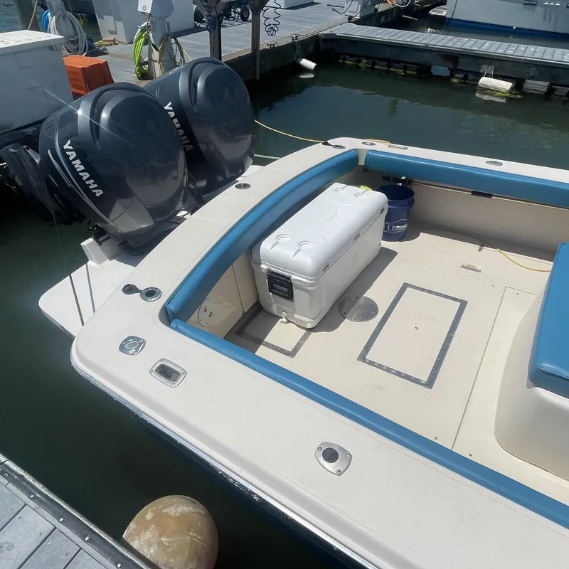 Slide: The Image of 1989 Rybo Runner Center Console boat with Yamaha engines docked at marina. - 19