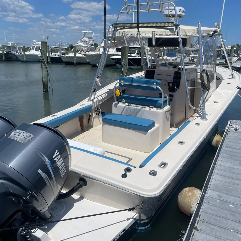 Slide: The Image of 1989 Rybo Runner Center Console boat with Yamaha engine docked at marina. - 20