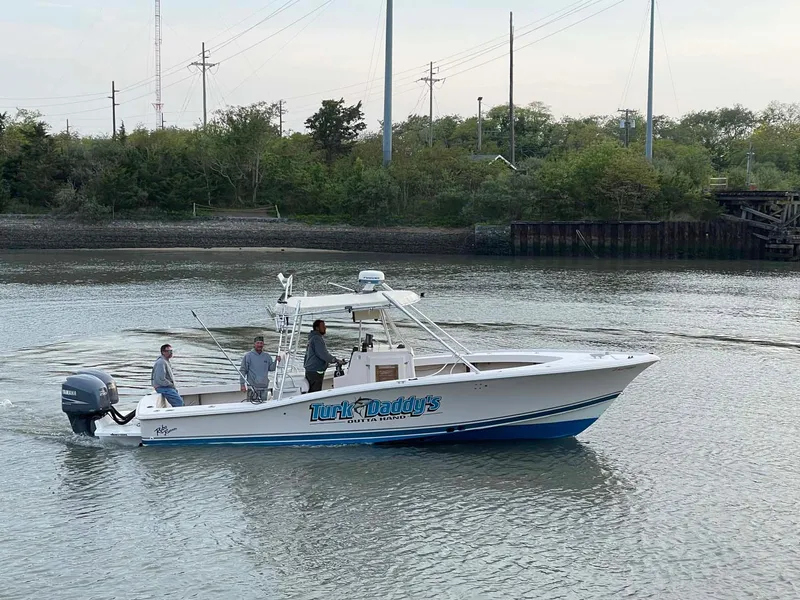 Slide: The Image of 1989 Rybo Runner Center Console boat cruising on a calm river. - 3