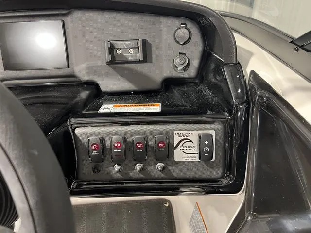 Slide: The Image of 2025 Yamaha AR190 boat dashboard with control panel and switches. - 17