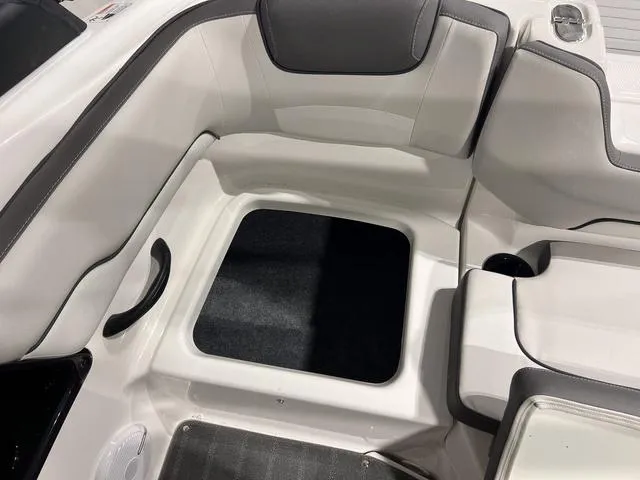 Slide: The Image of 2025 Yamaha Boats AR190 interior seating area with storage compartment. - 7