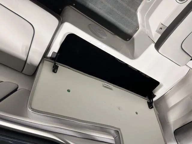 Slide: The Image of 2025 Yamaha AR190 boat interior storage compartment, open and empty. - 9