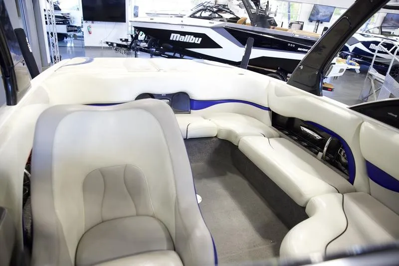 Slide: The Image of Interior of a 2008 Malibu 21 VLX boat with white and blue seating. - 13