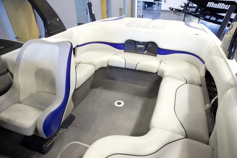 Slide: The Image of 2008 Malibu 21 VLX boat interior with white and blue seating. - 14