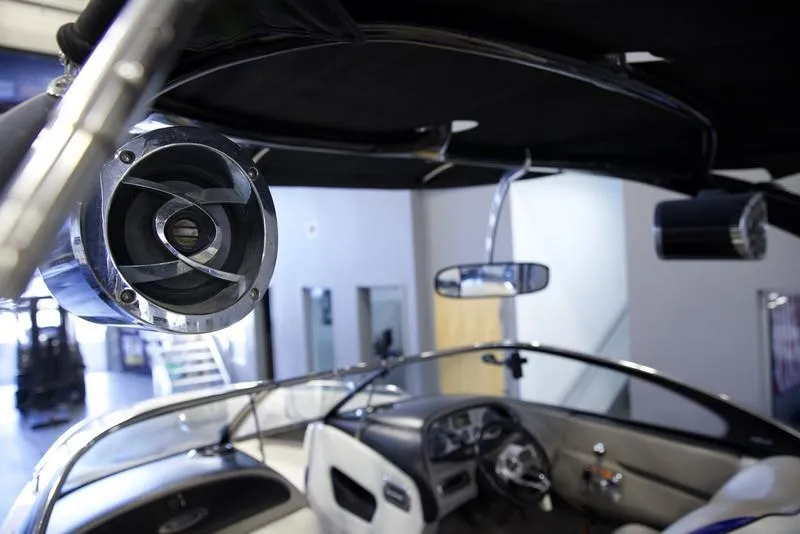 Slide: The Image of Interior of a 2008 Malibu 21 VLX boat with speaker and dashboard view. - 3