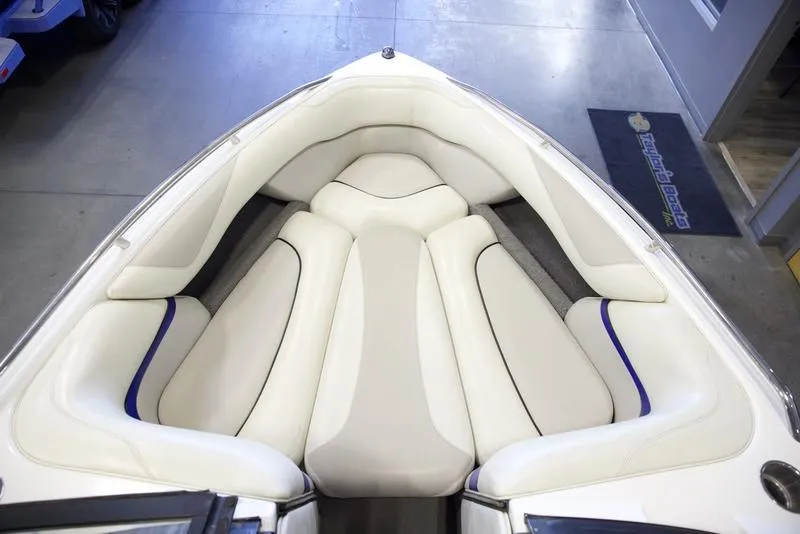 Slide: The Image of 2008 Malibu 21 VLX boat interior with white cushioned seating. - 4