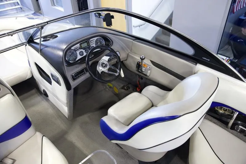 Slide: The Image of Interior of a 2008 Malibu 21 VLX boat with sleek dashboard and comfortable seating. - 5