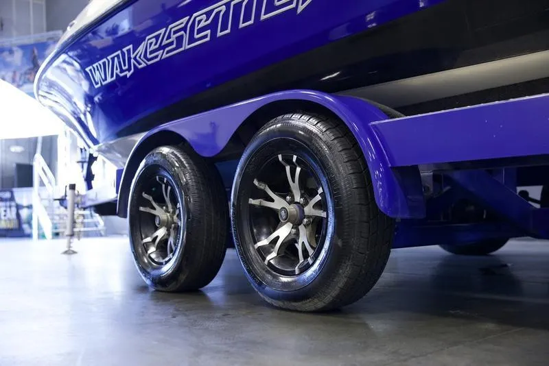 Slide: The Image of 2008 Malibu 21 VLX Wakesetter boat on trailer with stylish wheels. - 6