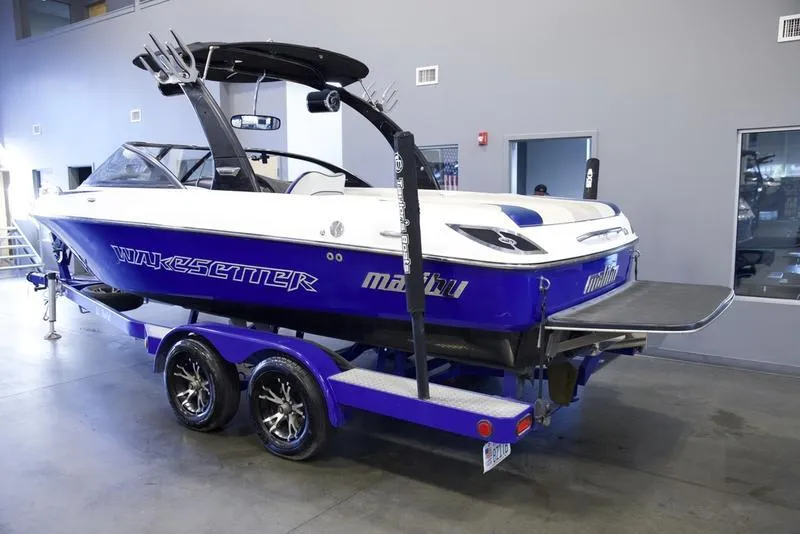 Slide: The Image of 2008 Malibu 21 VLX Wakesetter boat on trailer in showroom. - 7