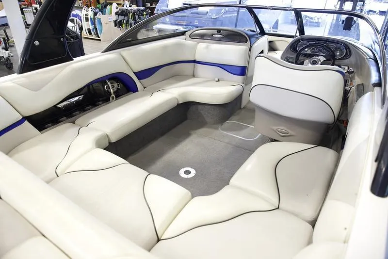 Slide: The Image of 2008 Malibu 21 VLX boat interior with white and blue seating. - 9