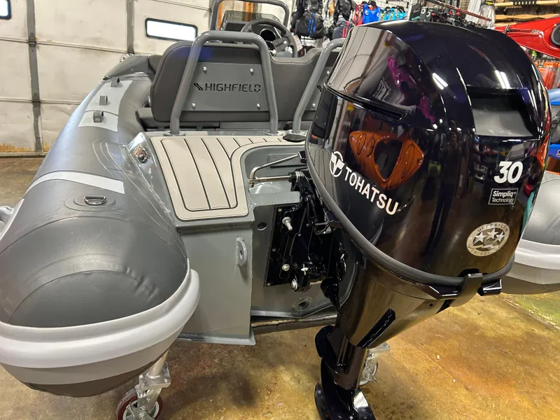 Slide: The Image of 2024 Highfield Sport 330 boat with Tohatsu 30 HP outboard motor in showroom. - 11