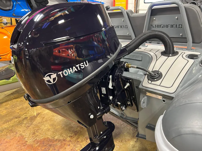 Slide: The Image of 2024 Highfield Sport 330 with Tohatsu outboard motor, showcasing sleek design and functionality. - 12
