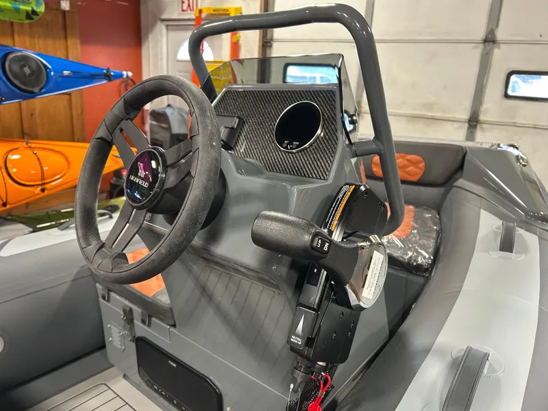 Slide: The Image of 2024 Highfield Sport 330 boat interior with steering wheel and control panel. - 5