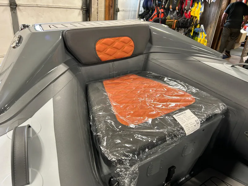 Slide: The Image of 2024 Highfield Sport 330 boat interior with orange quilted seat cushion. - 9