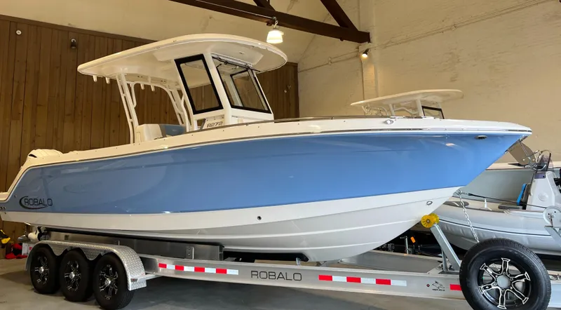 Slide: The Image of 2023 Robalo R 272 boat on trailer in indoor showroom. - 0