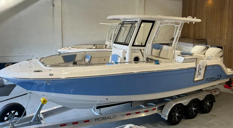 Slide: The Image of 2023 Robalo R 272 boat on trailer in showroom. - 1