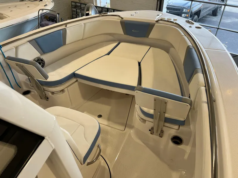 Slide: The Image of 2023 Robalo R 272 boat interior with white and blue seating. - 12