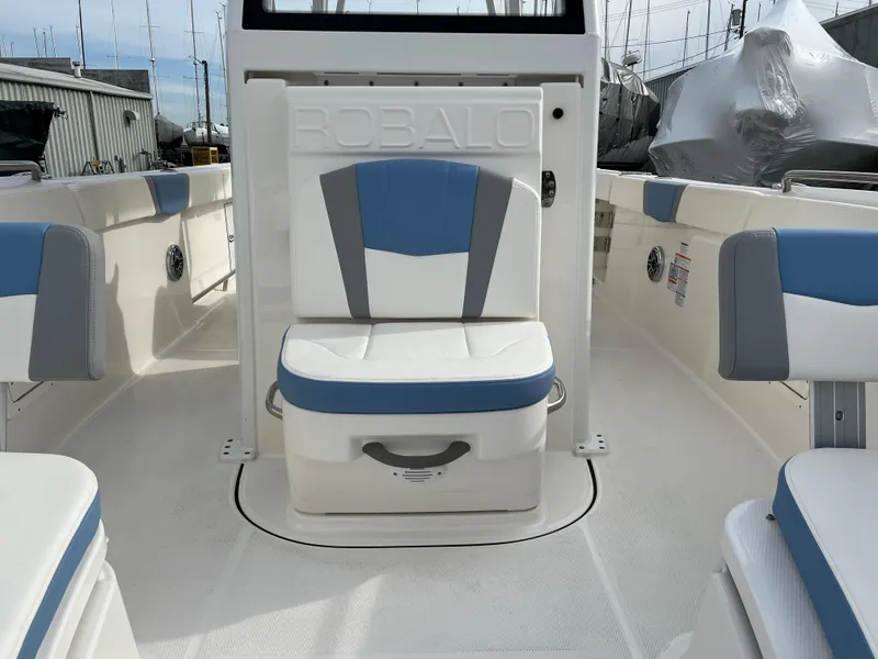 Slide: The Image of 2023 Robalo R 272 boat interior with blue and white seating. - 27