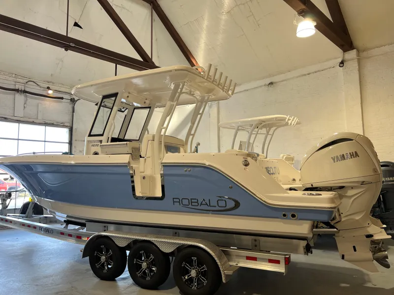 Slide: The Image of 2023 Robalo R 272 boat with Yamaha engine on trailer in showroom. - 4