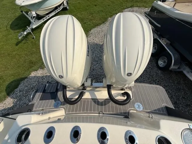 Slide: The Image of 2025 Scout 260 LXF boat with dual outboard engines on a trailer. - 10