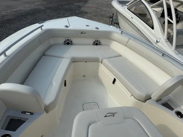 Slide: The Image of 2025 Scout 260 LXF boat interior with white cushioned seating and sleek design. - 2