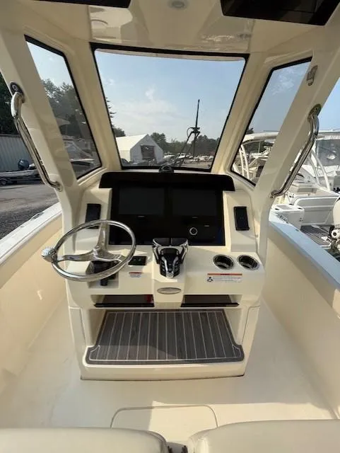 Slide: The Image of 2025 Scout 260 LXF boat cockpit with steering wheel and control panel. - 6