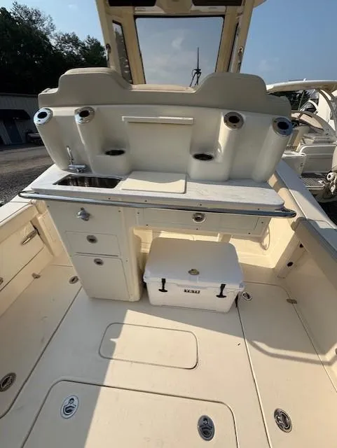 Slide: The Image of 2025 Scout 260 LXF boat interior with sink, storage, and cooler. - 7