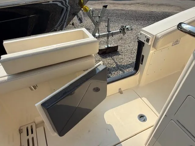 Slide: The Image of 2025 Scout 260 LXF boat interior with open storage compartment and seating. - 9