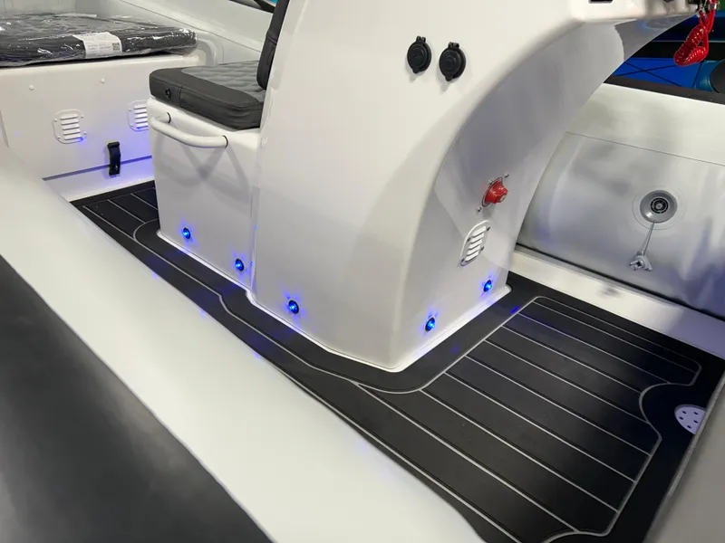 Slide: The Image of 2025 Highfield Sport 420 boat interior with sleek design and blue LED lights. - 16