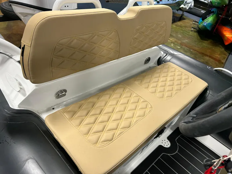 Slide: The Image of 2025 Highfield Sport 390 boat interior with beige diamond-stitched seating. - 10