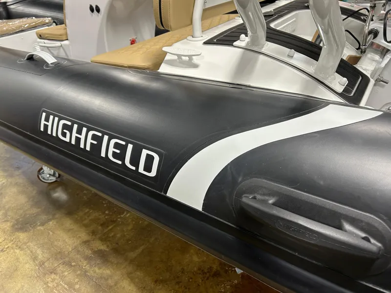 Slide: The Image of 2025 Highfield Sport 390 inflatable boat, black and white design, close-up view. - 11
