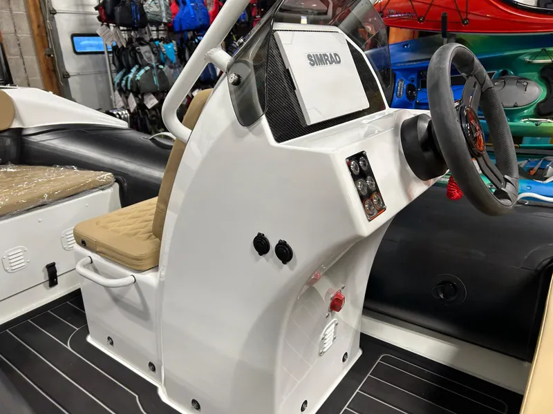 Slide: The Image of Highfield Sport 390 boat console, 2025 model, featuring steering wheel and control panel. - 12