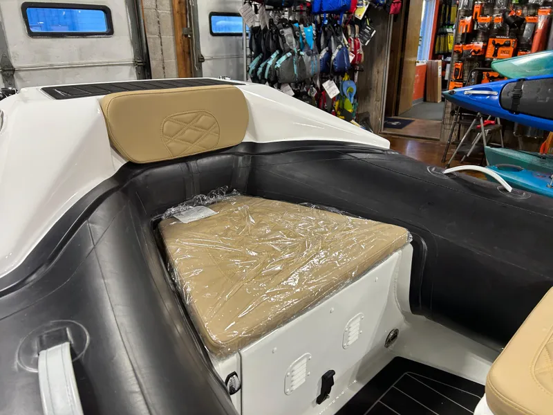 Slide: The Image of Highfield Sport 390 boat interior, 2025 model, featuring beige seating and storage area. - 13