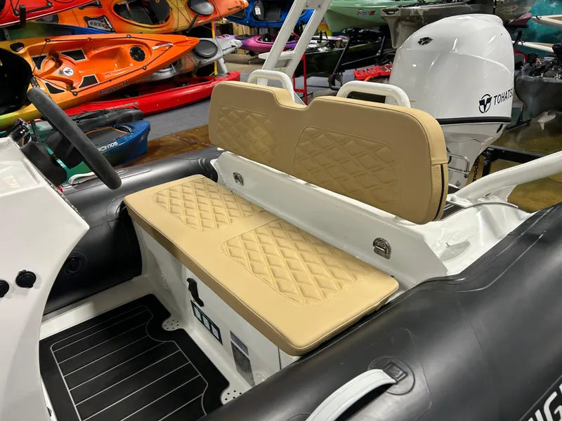 Slide: The Image of 2025 Highfield Sport 390 boat interior with tan quilted seats and black flooring. - 15