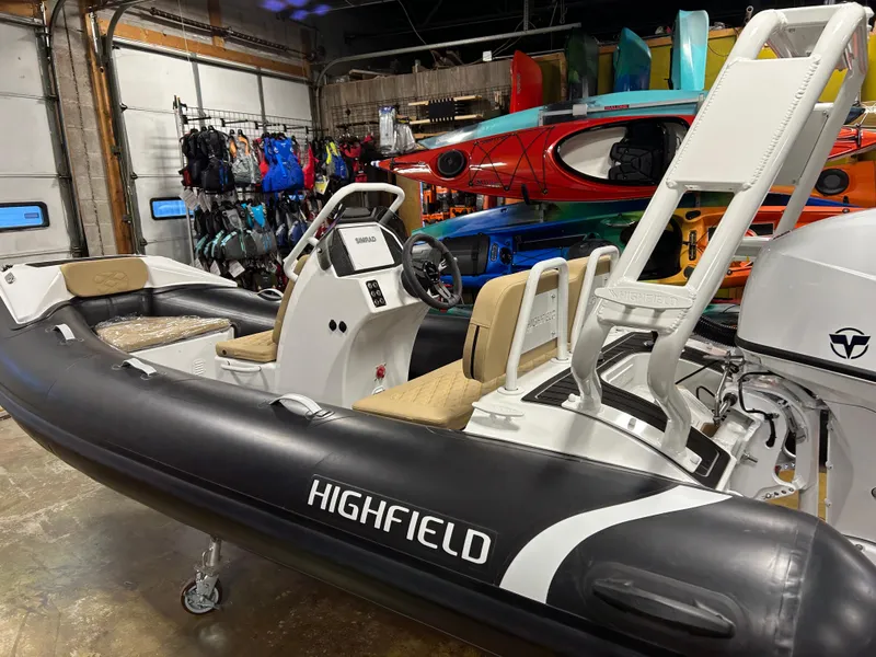 Slide: The Image of 2025 Highfield Sport 390 inflatable boat in showroom with kayaks and gear. - 4
