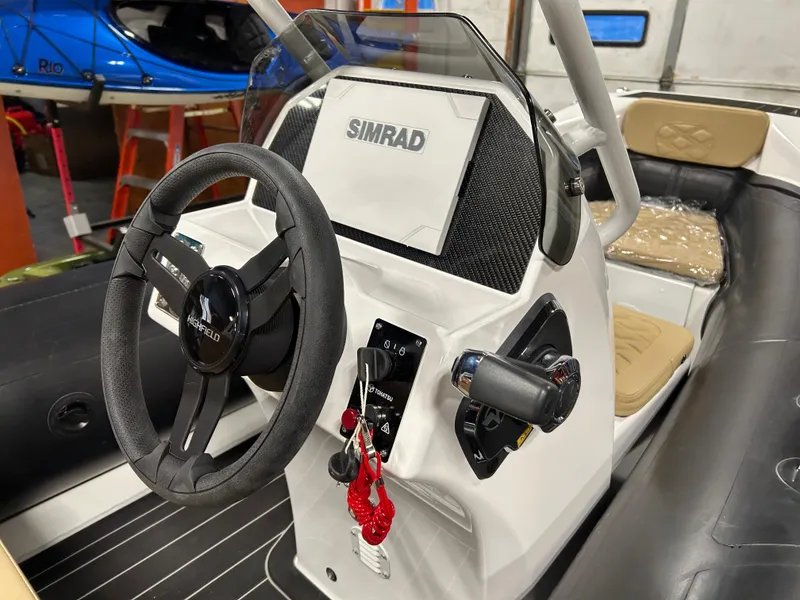 Slide: The Image of 2025 Highfield Sport 390 boat dashboard with Simrad navigation system. - 6