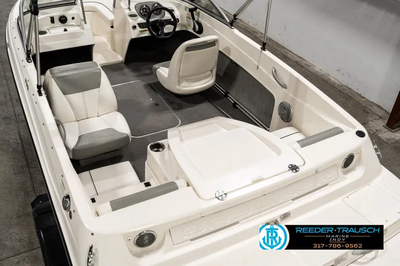Slide: The Image of 2013 Bayliner 175 boat interior with seating and steering wheel, Reeder-Trausch Marine logo. - 11