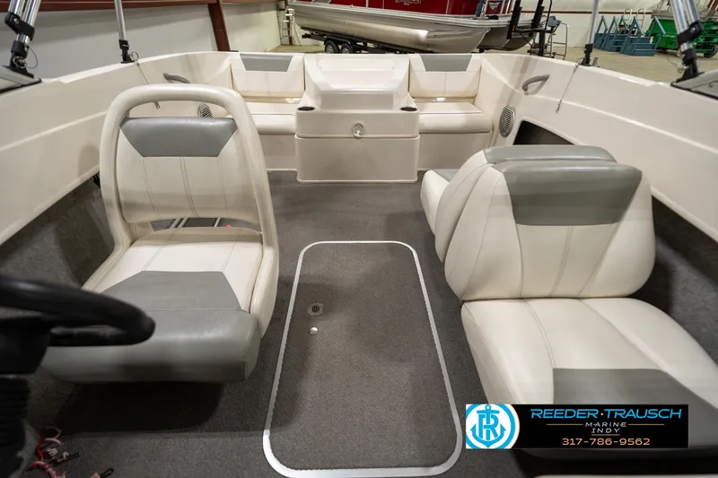 Slide: The Image of 2013 Bayliner 175 boat interior with white and gray seating. - 13
