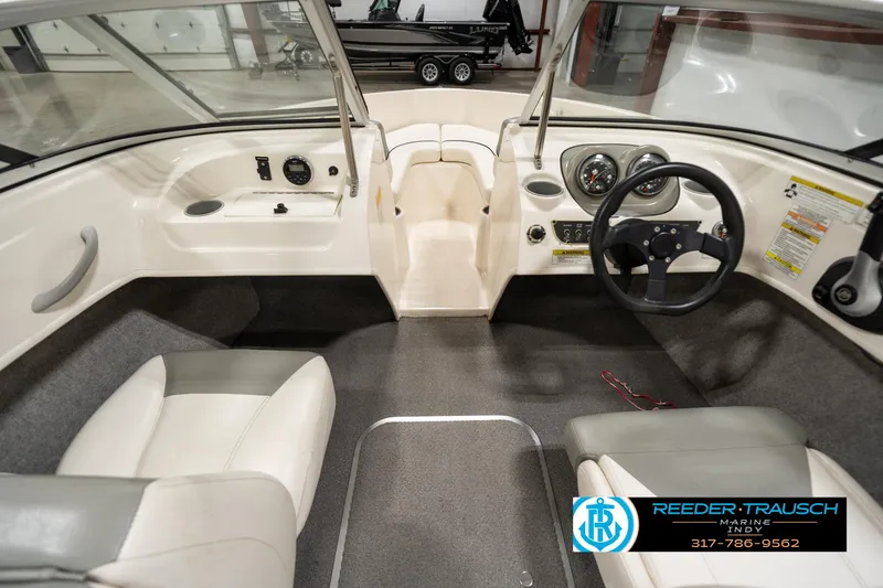 Slide: The Image of Interior of a 2013 Bayliner 175 boat with steering wheel and seating. - 16