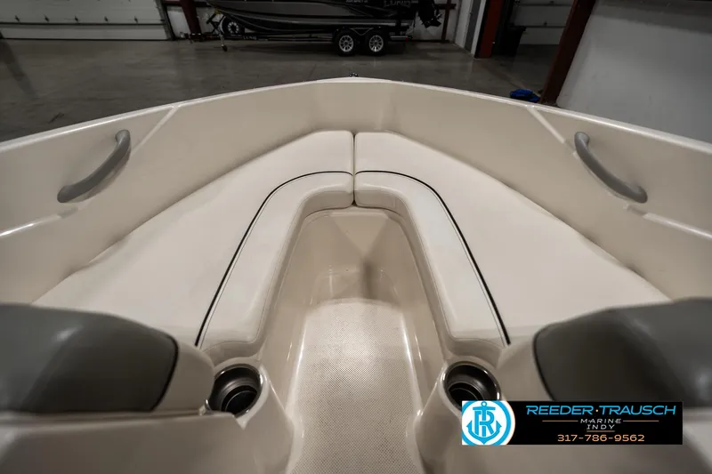Slide: The Image of 2013 Bayliner 175 boat interior with beige seating and cup holders. - 17