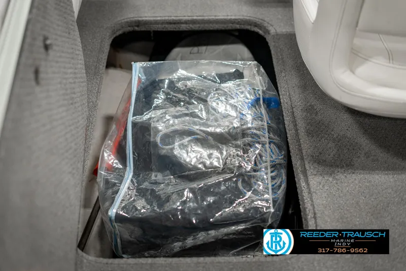 Slide: The Image of Storage compartment in a 2013 Bayliner 175 boat with packed items. - 20