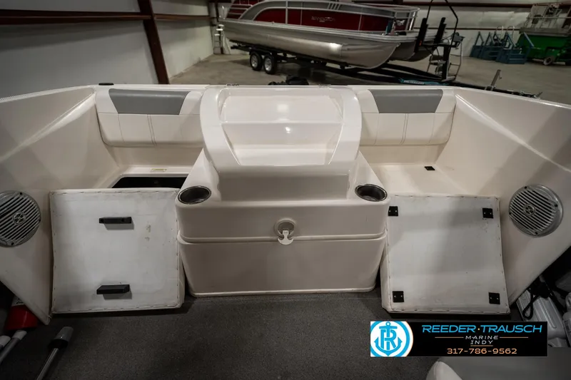 Slide: The Image of 2013 Bayliner 175 boat interior with storage compartments and cup holders. - 22