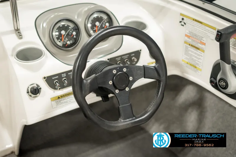 Slide: The Image of 2013 Bayliner 175 dashboard with steering wheel and gauges. - 25