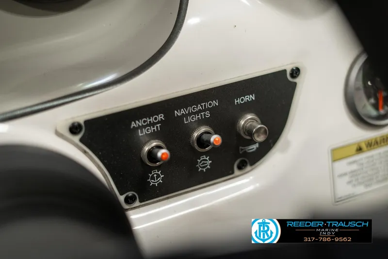 Slide: The Image of Control panel of a 2013 Bayliner 175 boat with switches for lights and horn. - 29