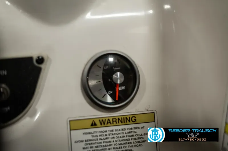 Slide: The Image of 2013 Bayliner 175 dashboard gauge with warning label and Reeder-Trausch Marine logo. - 30