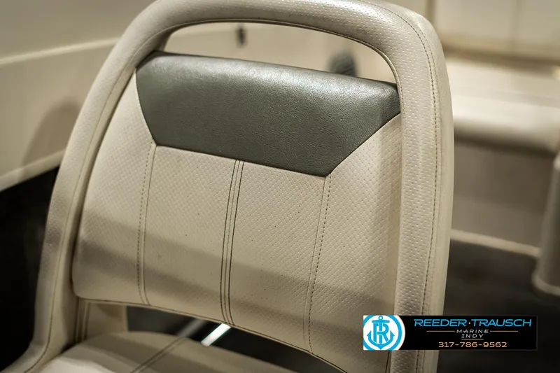 Slide: The Image of 2013 Bayliner 175 boat seat, beige and gray upholstery, Reeder-Trausch Marine logo visible. - 32