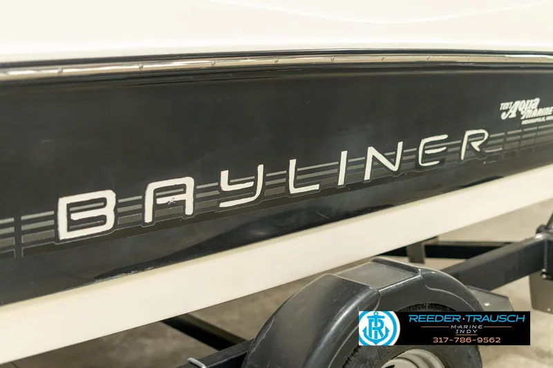 Slide: The Image of 2013 Bayliner 175 boat side view with trailer, Reeder-Trausch Marine logo visible. - 38