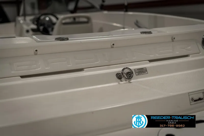 Slide: The Image of 2013 Bayliner 175 boat interior with steering wheel and branding. - 39